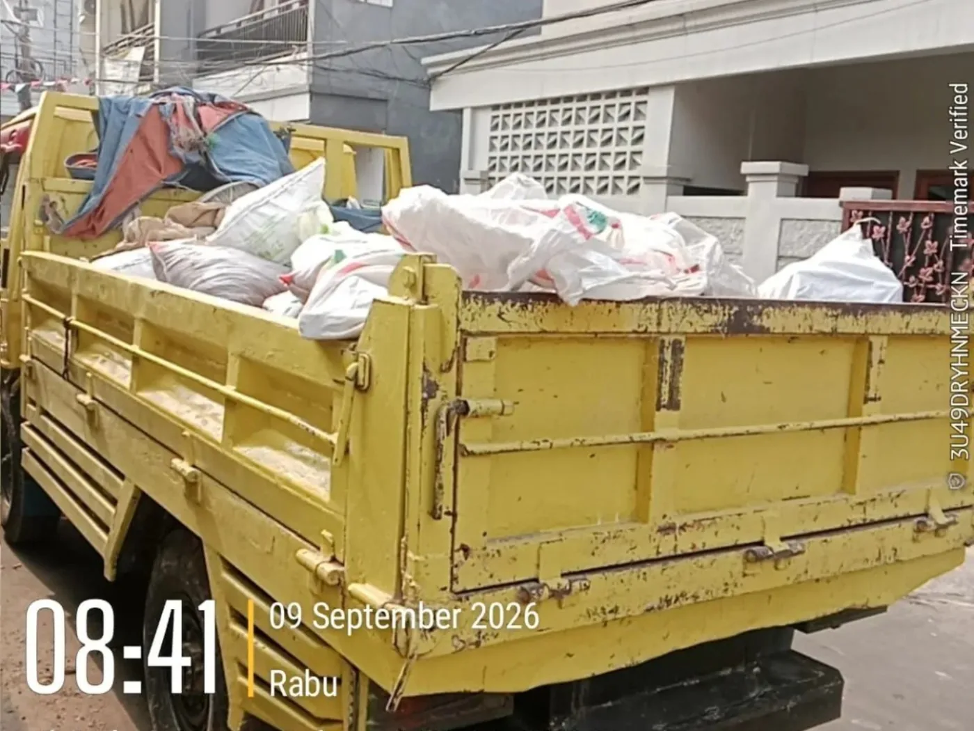 Truk mengangkut karung dan sampah sisa proyek